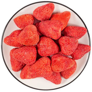 Freeze dried strawberry overview, vibrant red whole and sliced pieces