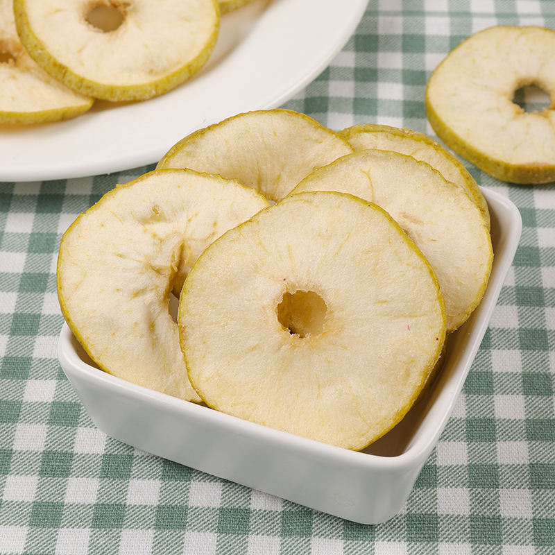 Vacuum fried green apple ring slice detail, center core hole and natural green edge
