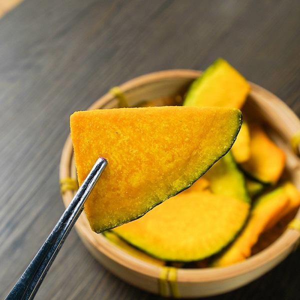 Vacuum fried pumpkin slice close up, natural deep orange color and crispy texture detail